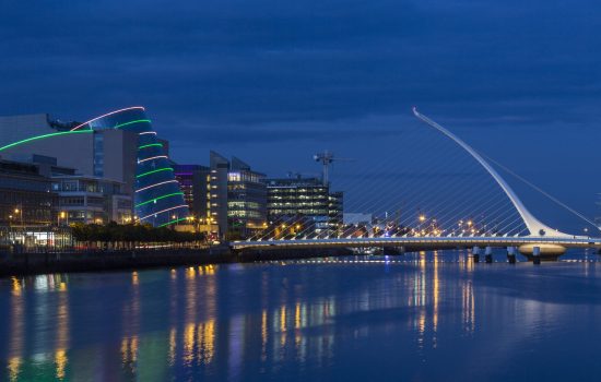 The River Liffey, the Samuel Beckett Bridge and the building on the waterfront near the Convention Center - Dublin city center in the republic of Ireland.